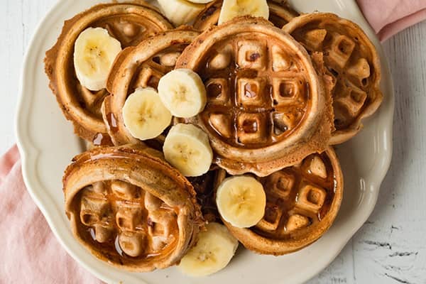 cinnamon-bun-waffle-mix cinnamon bun waffle topped with banana, made from commercial waffle mix
