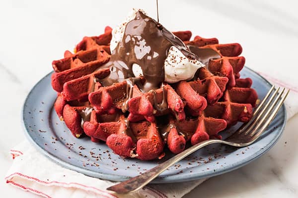 red-velvet-waffle-mix red velvet waffles with whipped cream and chocolate sauce